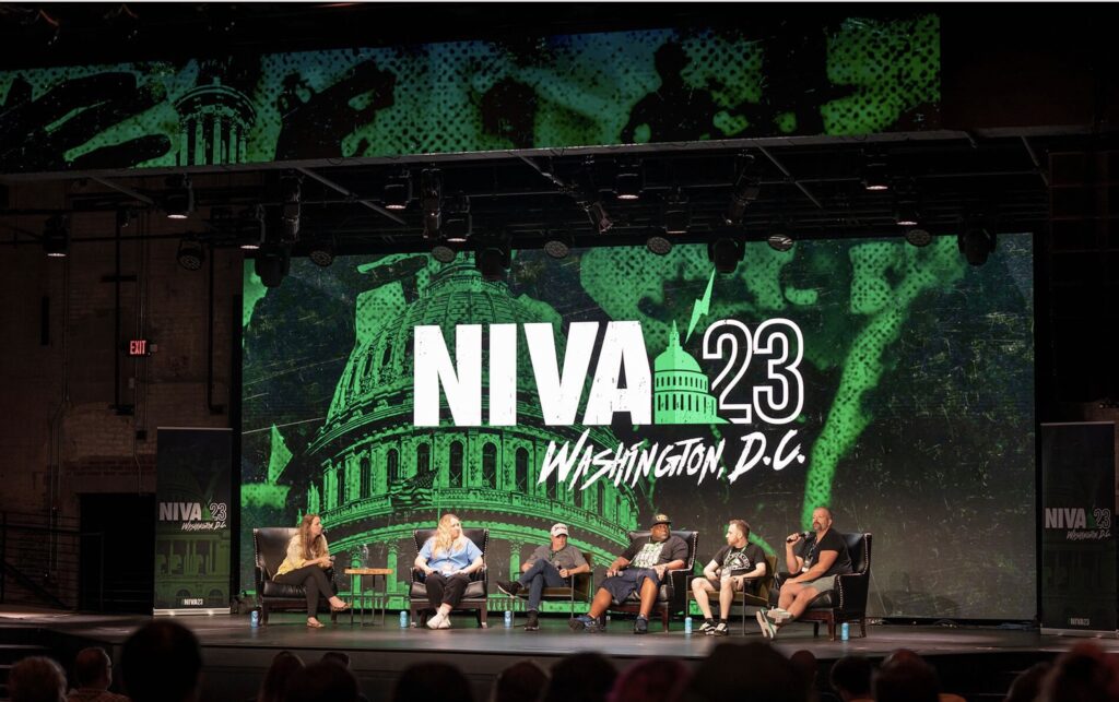 Photo of stage at NIVA Conference in DC with design work from Jason Gierl